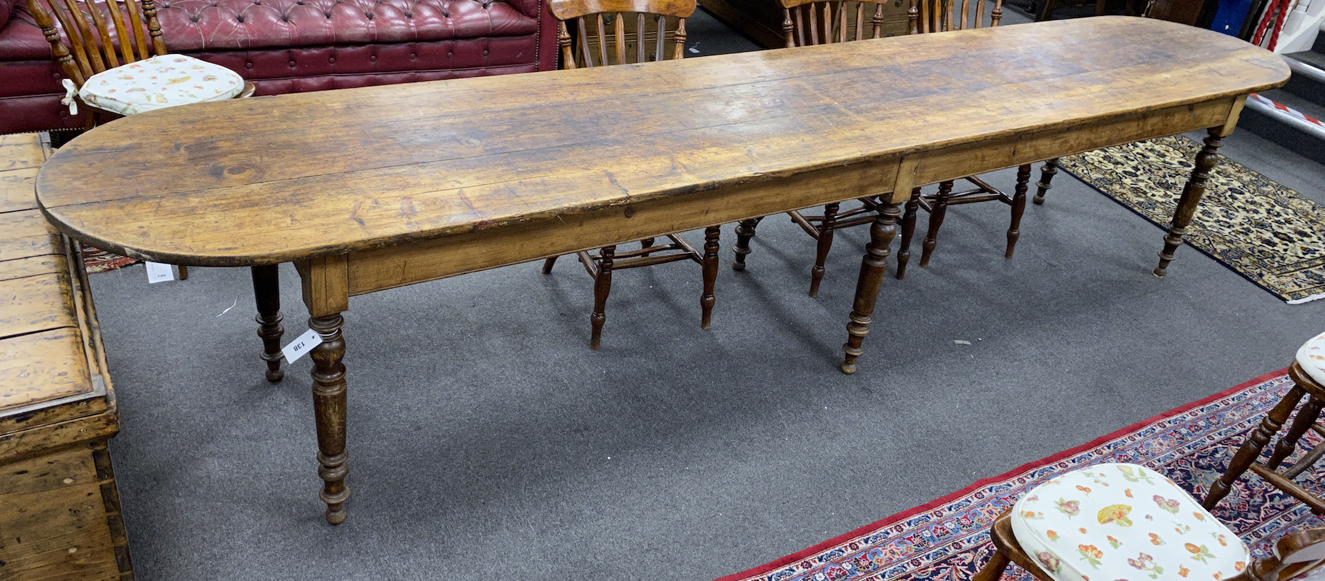 A 19th century French elm and fruitwood farmhouse table the triple planked top on six turned tapered legs, length 370cm, depth 67cm, height 73cm